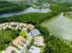 An aerial shot captures the homes nestled within lush greenery and alongside a tranquil lake at 21209 Diamonte Dr, Land O Lakes, FL 34637