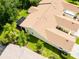 Aerial view of a residential home, screened in lanai, lush landscaping and mature trees at 21209 Diamonte Dr, Land O Lakes, FL 34637