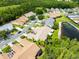 Aerial view of the community showcasing the lush green landscaping, nearby pond and well-maintained homes at 21209 Diamonte Dr, Land O Lakes, FL 34637