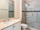 Bathroom showcasing granite countertops, white cabinetry and a glass enclosed shower at 21209 Diamonte Dr, Land O Lakes, FL 34637