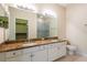 Bright bathroom with a double sink vanity, a large mirror, a walk-in shower, and tile flooring at 21209 Diamonte Dr, Land O Lakes, FL 34637