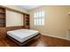 This versatile bedroom features a Murphy bed with built in storage cabinets and drawers and hardwood floors at 21209 Diamonte Dr, Land O Lakes, FL 34637