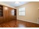 This versatile bedroom features a Murphy bed with built in storage cabinets and drawers and hardwood floors at 21209 Diamonte Dr, Land O Lakes, FL 34637