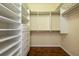 Walk-in closet with custom shelving, drawers, and hanging rods for optimal storage space and organization at 21209 Diamonte Dr, Land O Lakes, FL 34637