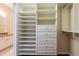 Walk-in closet with custom shelving, drawers, and hanging rods for optimal storage space and organization at 21209 Diamonte Dr, Land O Lakes, FL 34637