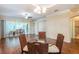 Bright dining area features wood floors, neutral paint, updated lighting and sliding glass doors to the outside patio at 21209 Diamonte Dr, Land O Lakes, FL 34637