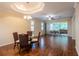 Open-concept dining room with hardwood floors, modern lighting, and access to outdoor patio at 21209 Diamonte Dr, Land O Lakes, FL 34637