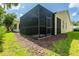 Exterior view of the screened-in patio, providing an insect-free outdoor space with a door for easy access at 21209 Diamonte Dr, Land O Lakes, FL 34637