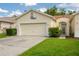 Charming single-Gathering home boasts a two-car garage, manicured lawn, and welcoming gated entrance at 21209 Diamonte Dr, Land O Lakes, FL 34637