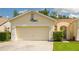 Well-maintained home features a two-car garage and a neatly landscaped front yard, under a bright sky at 21209 Diamonte Dr, Land O Lakes, FL 34637