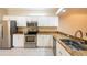 Modern kitchen features stainless steel appliances, granite countertops, and ample white cabinetry at 21209 Diamonte Dr, Land O Lakes, FL 34637
