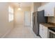 Bright kitchen eating area with tile floors, a modern pendant light, and a window with shutters at 21209 Diamonte Dr, Land O Lakes, FL 34637