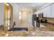 Well-lit kitchen with white cabinets, stainless steel appliances, and granite countertops at 21209 Diamonte Dr, Land O Lakes, FL 34637