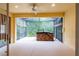 View of the covered and screened-in patio with hot tub overlooking a serene backyard at 21209 Diamonte Dr, Land O Lakes, FL 34637
