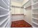 Spacious walk-in closet with hardwood floor and custom white built-in shelving at 21209 Diamonte Dr, Land O Lakes, FL 34637