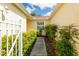 Serene walkway with lush landscaping on either side that leads to the home's entrance and lovely curb appeal at 21209 Diamonte Dr, Land O Lakes, FL 34637