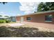 View of the backyard featuring a concrete patio and a building with a stucco exterior at 2121 23Rd Sw St, Largo, FL 33774