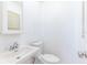 Small bathroom with a white sink, toilet, mirror, and bright white paint at 2121 23Rd Sw St, Largo, FL 33774