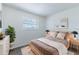 Comfortable bedroom with neutral paint, cozy bed, and light-colored flooring at 2121 23Rd Sw St, Largo, FL 33774