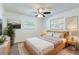 Bright bedroom features neutral décor, ceiling fan, wood bed frame, and plenty of natural light at 2121 23Rd Sw St, Largo, FL 33774
