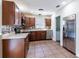 The kitchen features stainless steel appliances and sleek dark wood cabinetry at 2121 23Rd Sw St, Largo, FL 33774