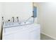 Laundry room featuring white washer and dryer units with exposed brick wall above at 2121 23Rd Sw St, Largo, FL 33774