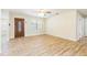 Open living area with wood-look tile flooring, window, and detailed front door at 2121 23Rd Sw St, Largo, FL 33774