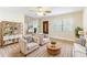 Cozy living room with furnishings, wood-look tile flooring, and neutral paint at 2121 23Rd Sw St, Largo, FL 33774