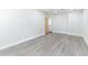 Bright living room with gray wood-look floors and fresh white walls at 2121 23Rd Sw St, Largo, FL 33774
