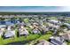 Wide aerial view of lakeside community and lush green landscaping and well-manicured lawns at 2227 North Creek Ct, Sun City Center, FL 33573