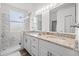 The primary bathroom features double sinks, a stone countertop, and a glass-enclosed shower at 2227 North Creek Ct, Sun City Center, FL 33573