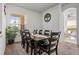 Dining area with a large wood table, seating for ten, and a view to the lanai at 2227 North Creek Ct, Sun City Center, FL 33573