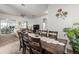 Open-concept dining area featuring a large table, seating for eight, and backyard views at 2227 North Creek Ct, Sun City Center, FL 33573