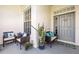 Inviting front porch with comfortable seating, decorative pillows, plants, and a stylish welcome mat at 2227 North Creek Ct, Sun City Center, FL 33573