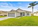 Beautiful single-story home featuring a manicured lawn, screened entryway, and attached two-car garage at 2227 North Creek Ct, Sun City Center, FL 33573