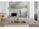 Kitchen with granite countertops, stainless steel sink and view of the living room at 2227 North Creek Ct, Sun City Center, FL 33573