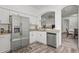 Bright kitchen with granite countertops, stainless steel appliances, and modern white cabinets at 2227 North Creek Ct, Sun City Center, FL 33573