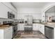 Modern kitchen featuring granite countertops, stainless steel appliances, and bright white cabinets at 2227 North Creek Ct, Sun City Center, FL 33573