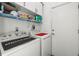 This laundry room includes both a washer and dryer, overhead shelving, and a storage closet at 2227 North Creek Ct, Sun City Center, FL 33573