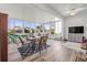 Bright sunroom with a view of the golf course and a dining area set for entertaining at 2227 North Creek Ct, Sun City Center, FL 33573