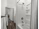 Clean bathroom with a tiled shower featuring toiletry storage, tiled floors and a nearby linen closet at 2720 14Th N Ave, St Petersburg, FL 33713