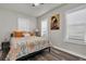 Cozy bedroom features hardwood floors, a bed with colorful linens, and windows with plantation shutters at 2720 14Th N Ave, St Petersburg, FL 33713