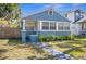 Quaint blue bungalow with a welcoming front porch and well-kept lawn at 2720 14Th N Ave, St Petersburg, FL 33713