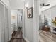 Hallway view with open doorways to storage and a brightly lit bathroom at 2720 14Th N Ave, St Petersburg, FL 33713