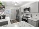 Well-lit kitchen featuring stainless steel appliances, marble countertops, decorative backsplash, and stylish grey cabinets at 2720 14Th N Ave, St Petersburg, FL 33713