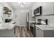 Modern kitchen featuring stainless steel appliances, marble countertops, decorative backsplash, and sleek grey cabinets at 2720 14Th N Ave, St Petersburg, FL 33713