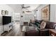 Bright living room featuring a large leather couch, modern ceiling fan, and neutral color palette at 2720 14Th N Ave, St Petersburg, FL 33713