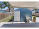 Enclosed outdoor area with a utility sink and a covered patio featuring a blue shed and green landscaping at 2720 14Th N Ave, St Petersburg, FL 33713