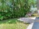 Lush backyard with brick patio and playground perfect for outdoor enjoyment and Gathering fun at 3003 W Leila Ave, Tampa, FL 33611