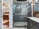 Bathroom offering a frameless shower, dark wood vanity, and a bright window at 3003 W Leila Ave, Tampa, FL 33611